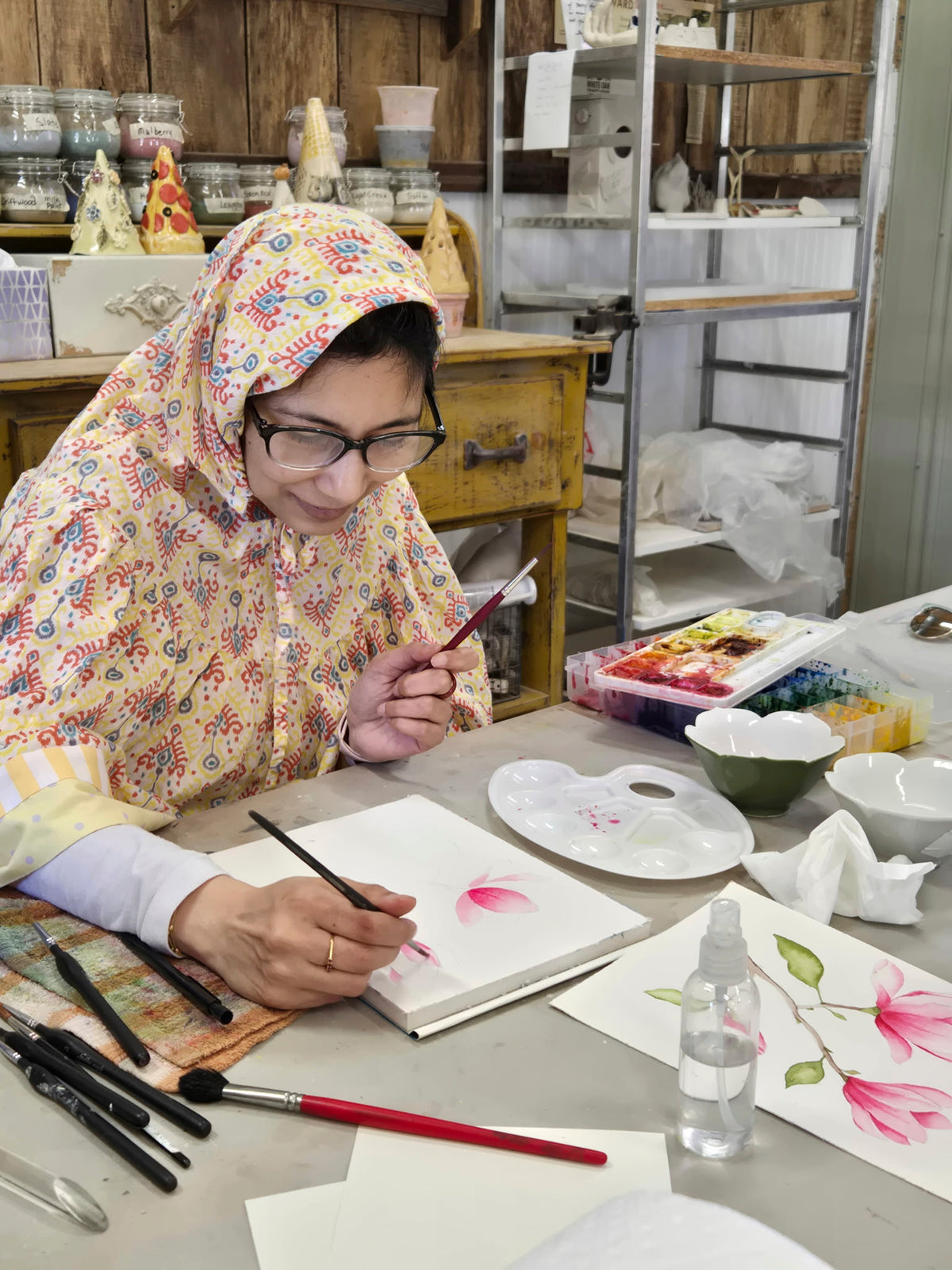 Guests painting watercolor flowers at a Finding Joy with Flowers workshop